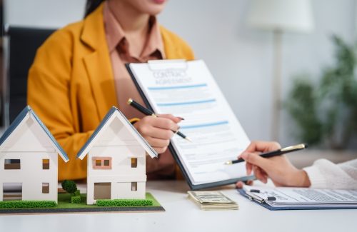 Asian,Businesswoman,Discusses,Home,Purchase,Contracts,With,Clients,At,Her